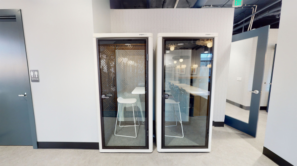 2 privacy booths with barstool and desk inside